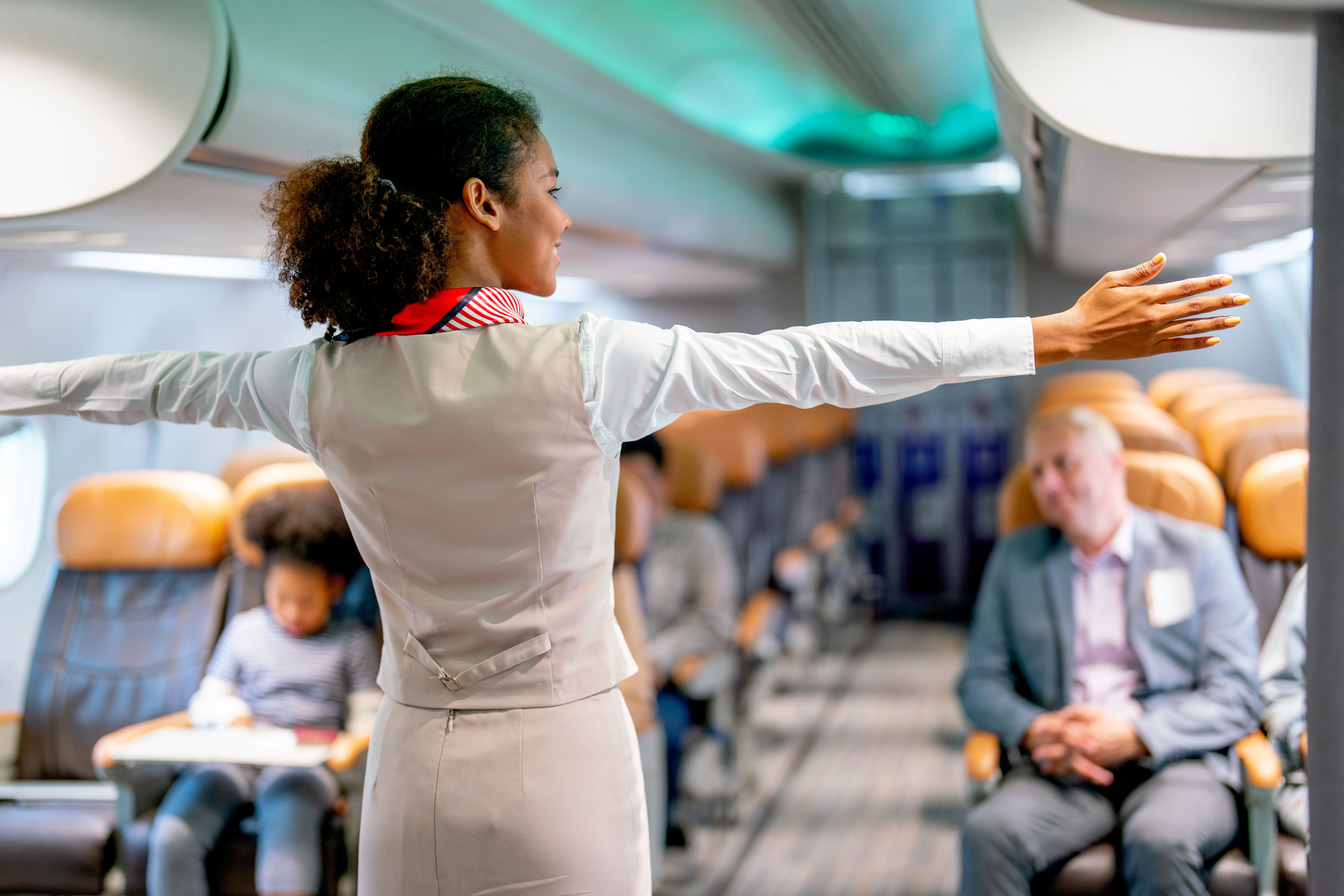 flight attendant welcoming passengers